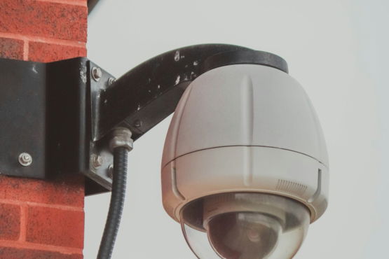 a security camera attached to a brick wall